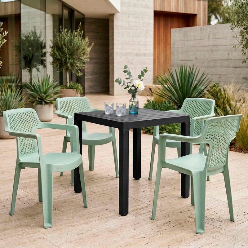 Mia dining set, with a black Barú table and 4 sage green Mia chairs on a terrace